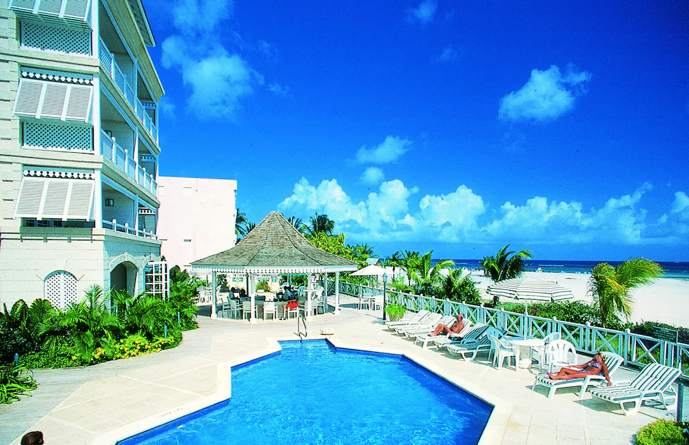 The pool and beachfront setting at Coral Sands Beach Resort in Barbados
