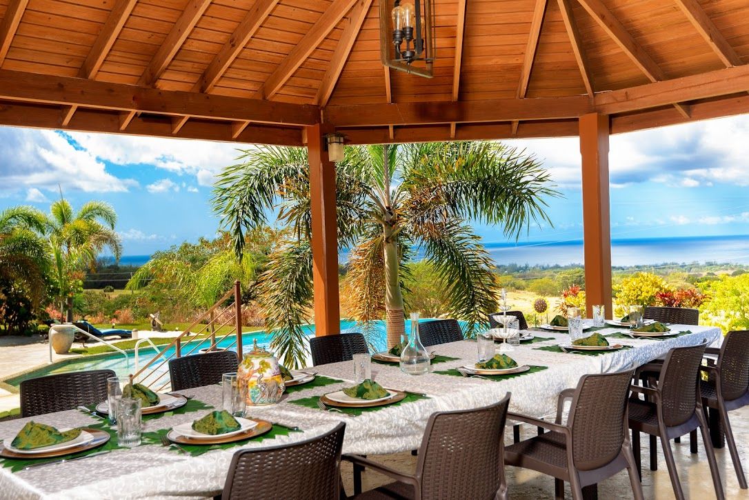 The open-air dining pavilion at La Maison Michelle overlooking the pool and sea