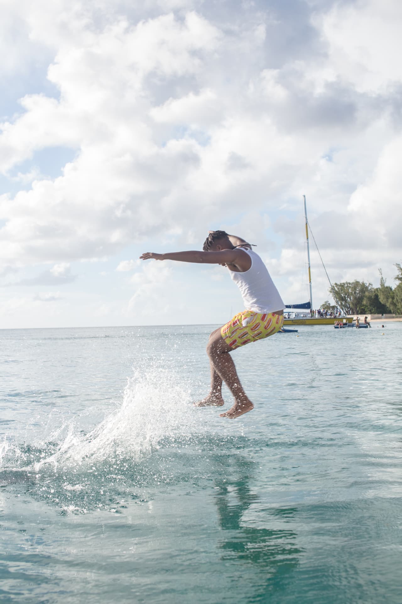 A Sankofa traveler leaping into the clear Caribbean Sea