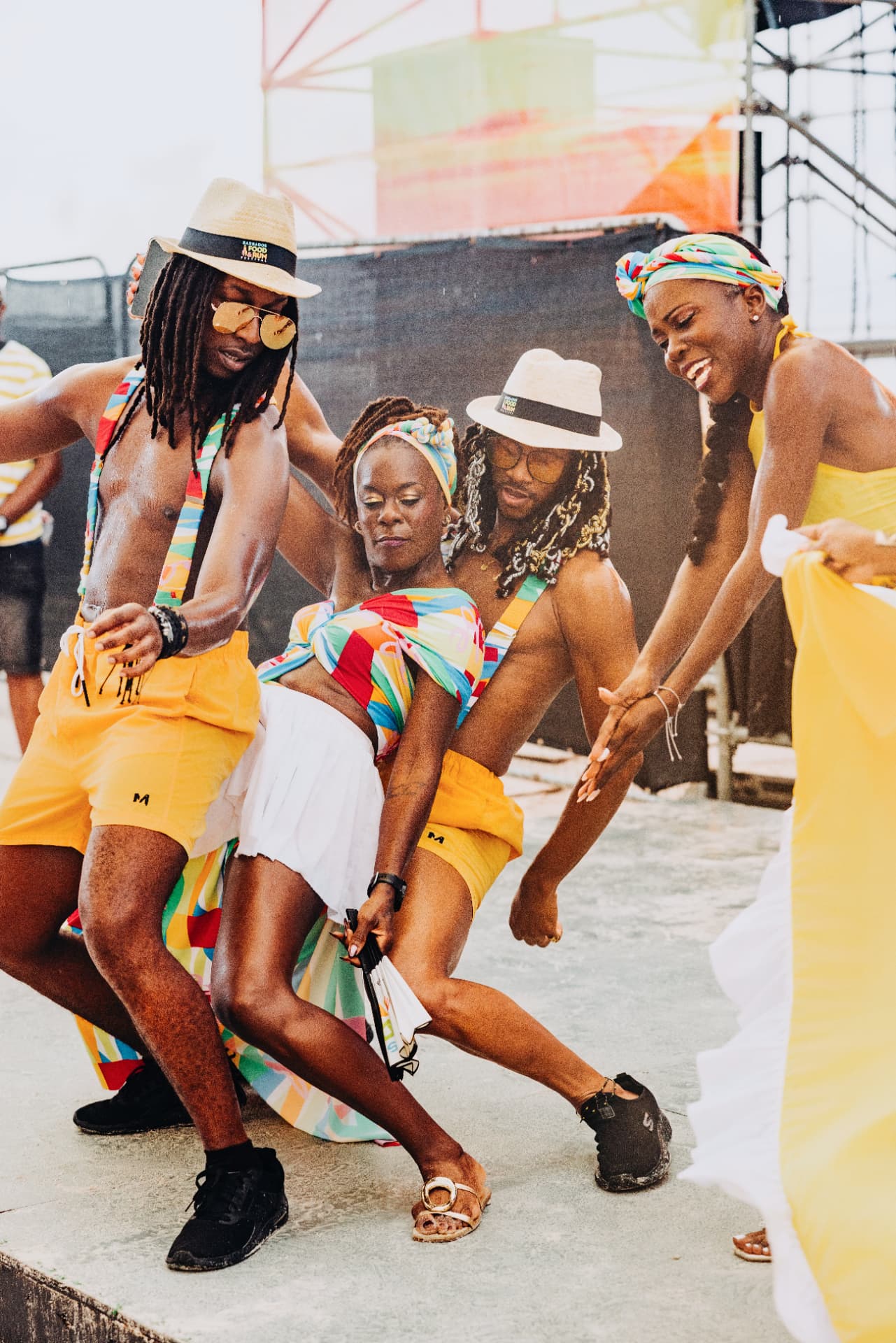 Dancers in bright festival colors moving together in the daytime