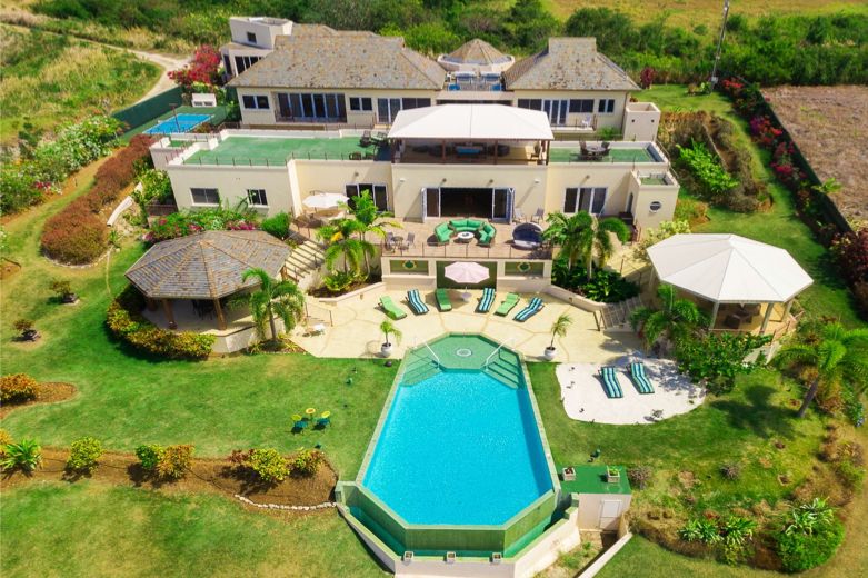 Aerial view of the La Maison Michelle estate, pool, gardens and the sea beyond