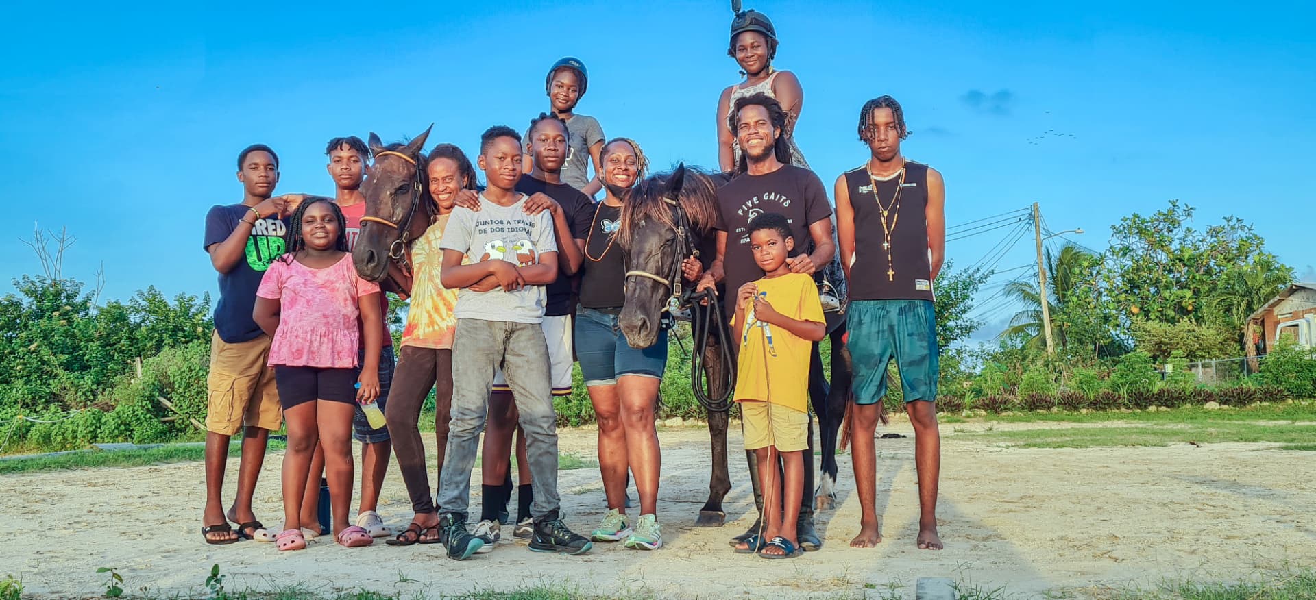 A multigenerational Sankofa group gathered with horses in Barbados